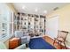 Spacious home office with floor-to-ceiling bookshelf and lots of natural light at 16730 Se 78Th Lillywood Ct, The Villages, FL 32162