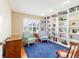 Inviting home office featuring a large built-in bookcase and comfortable seating at 16730 Se 78Th Lillywood Ct, The Villages, FL 32162