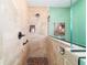 Close-up of the shower featuring beige tile, pebble floor and built-in storage niche at 16730 Se 78Th Lillywood Ct, The Villages, FL 32162
