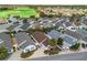 An aerial of a residential neighborhood showcasing the property with well-maintained landscaping at 1762 Meadowlark Ave, The Villages, FL 32162