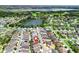 Aerial view showcasing a home's proximity to a golf course, putting green, and scenic pond at 1762 Meadowlark Ave, The Villages, FL 32162