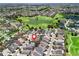 An aerial view shows the home's location near a pond, golf course, and other residences at 1762 Meadowlark Ave, The Villages, FL 32162