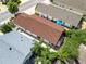 Aerial view of the house featuring a new roof, mature landscaping, and a screened-in lanai at 1762 Meadowlark Ave, The Villages, FL 32162