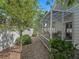 Backyard featuring a screened-in patio, manicured landscaping, and a privacy fence at 1762 Meadowlark Ave, The Villages, FL 32162