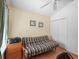 Spare bedroom featuring a futon, closet, window, and wood-look flooring at 1762 Meadowlark Ave, The Villages, FL 32162