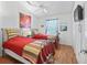 Comfortable guest bedroom with two beds, ceiling fan and a window with blue curtains at 1762 Meadowlark Ave, The Villages, FL 32162