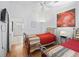Well-lit guest bedroom featuring a TV, two beds, and wood-look flooring at 1762 Meadowlark Ave, The Villages, FL 32162
