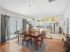 Open-concept living featuring a dining area flowing into a modern kitchen with bar seating at 1762 Meadowlark Ave, The Villages, FL 32162