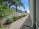 Well-maintained backyard featuring a walkway and a privacy fence with a landscaped border at 1762 Meadowlark Ave, The Villages, FL 32162