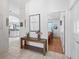 Inviting hallway featuring tile flooring and a view into a bedroom with wood floors at 1762 Meadowlark Ave, The Villages, FL 32162