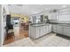Open-concept kitchen with ample counter space and a view into the dining and living areas at 1762 Meadowlark Ave, The Villages, FL 32162