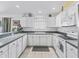 Bright kitchen with white cabinets, countertops, and tile flooring at 1762 Meadowlark Ave, The Villages, FL 32162
