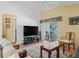 Cozy living room with access to the screened patio, offering an indoor-outdoor living experience at 1762 Meadowlark Ave, The Villages, FL 32162