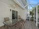 Screened patio features neutral tile, seating, and ceiling fan, perfect for outdoor living at 1762 Meadowlark Ave, The Villages, FL 32162
