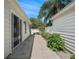 An outdoor walkway with landscaped borders connects the home to its detached, white-sided garage at 1762 Meadowlark Ave, The Villages, FL 32162