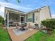 Backyard patio with seating, outdoor grill, and access to the screened in porch at 17860 Se 89Th Natchez Ave, The Villages, FL 32162