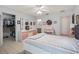 Airy bedroom boasts neutral tile flooring, walk-in closet, and convenient access to ensuite bathroom at 17860 Se 89Th Natchez Ave, The Villages, FL 32162