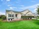 Inviting single-story home with a cozy front patio area, lush lawn, and pleasing exterior at 17860 Se 89Th Natchez Ave, The Villages, FL 32162
