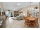 Open-concept living area with tile floors, natural light, and a dining area, ideal for comfortable living at 17860 Se 89Th Natchez Ave, The Villages, FL 32162