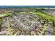 An expansive aerial view showcasing the community amenities, golf course, clubhouse, and tennis courts at 2101 Southern Star Way, The Villages, FL 32162