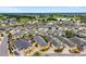 Expansive aerial view of a residential community with manicured lawns, lush greenery, and a scenic golf course in the background at 2101 Southern Star Way, The Villages, FL 32162