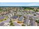 A high-angle view showcasing a well-maintained neighborhood with mature landscaping, a golf course, and a serene lake at 2101 Southern Star Way, The Villages, FL 32162