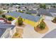 Aerial view of a charming home featuring a well-kept lawn, landscaping and driveway at 2101 Southern Star Way, The Villages, FL 32162