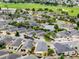 Bird's eye view of the property showcasing lush landscaping, golf course proximity, and well-kept neighboring homes at 2101 Southern Star Way, The Villages, FL 32162