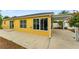 Exterior view of home showcasing the paved patio and well-maintained yard at 2101 Southern Star Way, The Villages, FL 32162