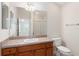 Bathroom with a single sink vanity, large mirror, and a toilet at 2101 Southern Star Way, The Villages, FL 32162
