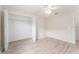 Bedroom with a ceiling fan, light walls and a closet with the doors open at 2101 Southern Star Way, The Villages, FL 32162