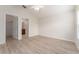 The bedroom features wood floors, a closet, a ceiling fan, neutral paint and access to a bathroom at 2101 Southern Star Way, The Villages, FL 32162