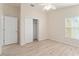 Bedroom with closet, window, wood flooring and ceiling fan at 2101 Southern Star Way, The Villages, FL 32162