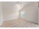 The bedroom features wood floors, a ceiling fan, a window with blinds, and neutral colored walls at 2101 Southern Star Way, The Villages, FL 32162