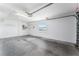 Spacious garage with shelving on the back wall and a window at 2101 Southern Star Way, The Villages, FL 32162