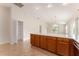 Tile flooring spans the kitchen with the breakfast bar that overlooks the living area and sliding glass doors at 2101 Southern Star Way, The Villages, FL 32162