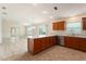 Open concept kitchen featuring stainless steel appliances, tile floors, a peninsula, and backyard views at 2101 Southern Star Way, The Villages, FL 32162