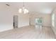 Open concept living room area with recessed lighting, tile floors, ceiling fan, and chandelier at 2101 Southern Star Way, The Villages, FL 32162