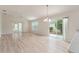 Open concept living room area, tile floors, with backyard views and a sliding glass door at 2101 Southern Star Way, The Villages, FL 32162