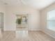 Bright living room featuring wood floors, a ceiling fan, sliding glass doors leading to the screened in back porch at 2101 Southern Star Way, The Villages, FL 32162