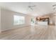 Open concept living room and kitchen area, tile floors, with backyard views and a sliding glass door at 2101 Southern Star Way, The Villages, FL 32162