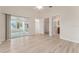 Bright main bedroom with sliding glass doors, light wood floors, neutral paint, and ceiling fan at 2101 Southern Star Way, The Villages, FL 32162