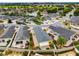 Aerial of the home showcasing a covered patio, manicured landscaping, and the community surroundings at 2101 Southern Star Way, The Villages, FL 32162