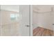 This bedroom features a walk-in closet with wire shelving and wood flooring at 2101 Southern Star Way, The Villages, FL 32162