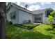 Landscaped backyard with artificial turf patio area and outdoor seating, offering a relaxing outdoor space at 2110 Churchill Downs Cir, Orlando, FL 32825