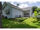 Lush backyard with artificial turf patio and outdoor seating, framed by mature trees, offering a serene space at 2110 Churchill Downs Cir, Orlando, FL 32825