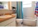 Bright and clean bathroom with a vanity, toilet, tub, and shower at 2110 Churchill Downs Cir, Orlando, FL 32825