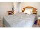 Bedroom with a wooden headboard, closet, and bookshelf offering comfort and convenience at 2110 Churchill Downs Cir, Orlando, FL 32825