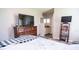 Bedroom with a flatscreen television and views into the bathroom at 2110 Churchill Downs Cir, Orlando, FL 32825