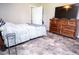 Bright bedroom with gray flooring, a dresser, and a comfortable bed at 2110 Churchill Downs Cir, Orlando, FL 32825